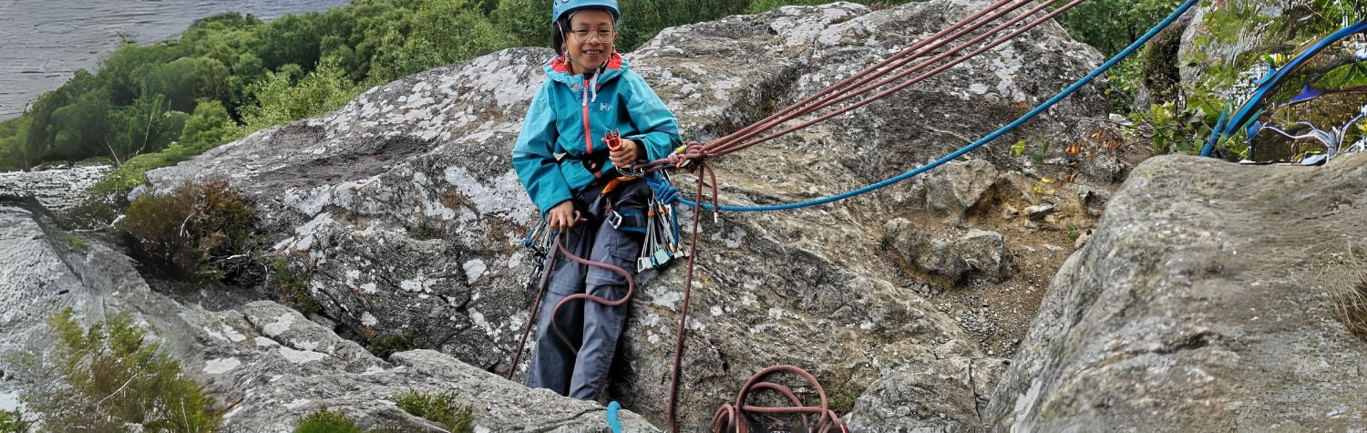 Young Boy trad climbing