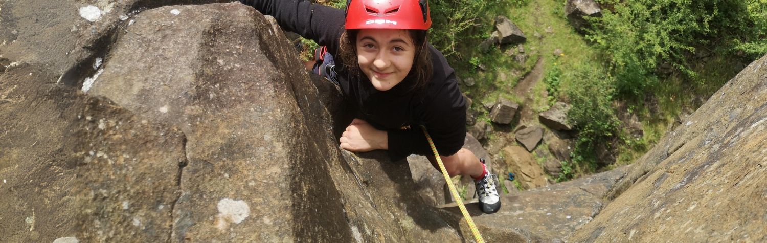 Young girl trad climbing