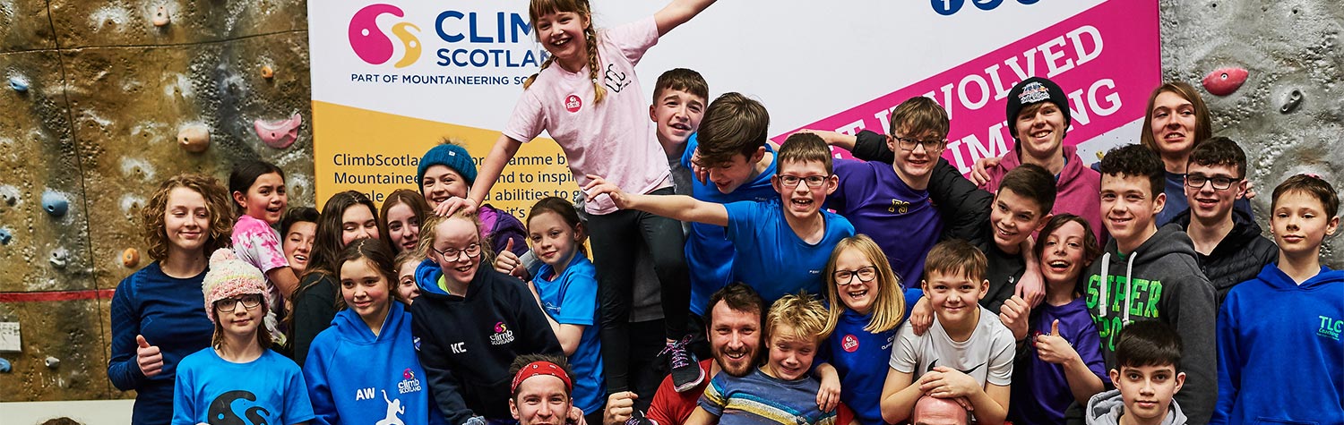 A group of young people at an indoor climbing wall