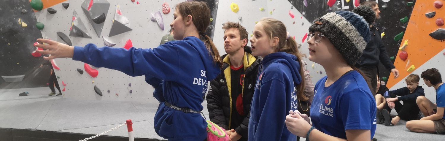 Coach working with three young girls